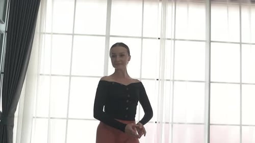 Friends practice ballet dance at studio.