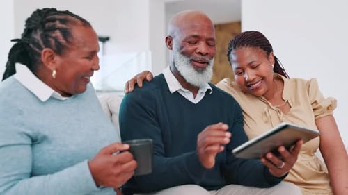Family Laughing Looking at Tablet at Home