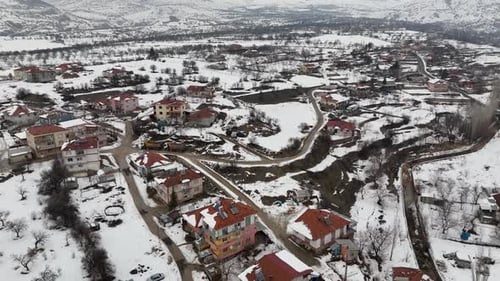 Snow Covered Town Center in Winter – Aerial Drone View of District with Mountains