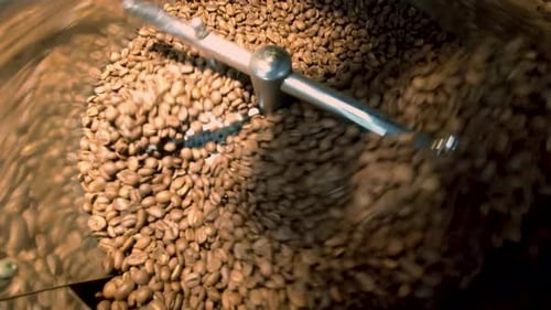 Coffee Beans Being Roasted in a Metal Container