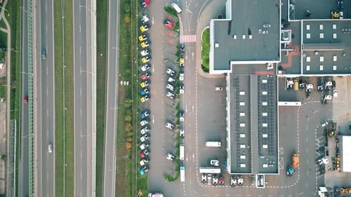 Aerial shot on a logistics park with a warehouse - a loading hub. Semi-trailers stand on ramps for l