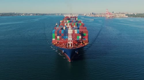 Aerial View Freight Ship Departs Halifax Port At Sunrise With Tugboat Escort