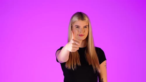 Pretty Young Blonde Woman Thumb-Up Gesture, Ok Yes Hand and Finger Sign, Colorful Studio Portrait