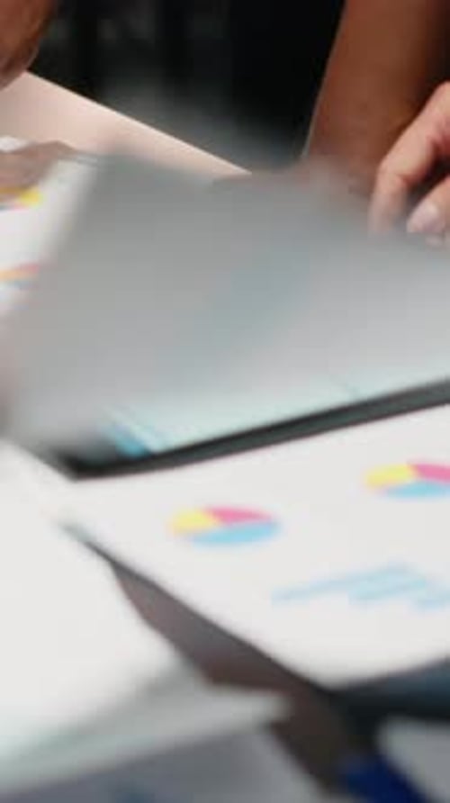 Corporate Team Reviews Financial Data on Tablet