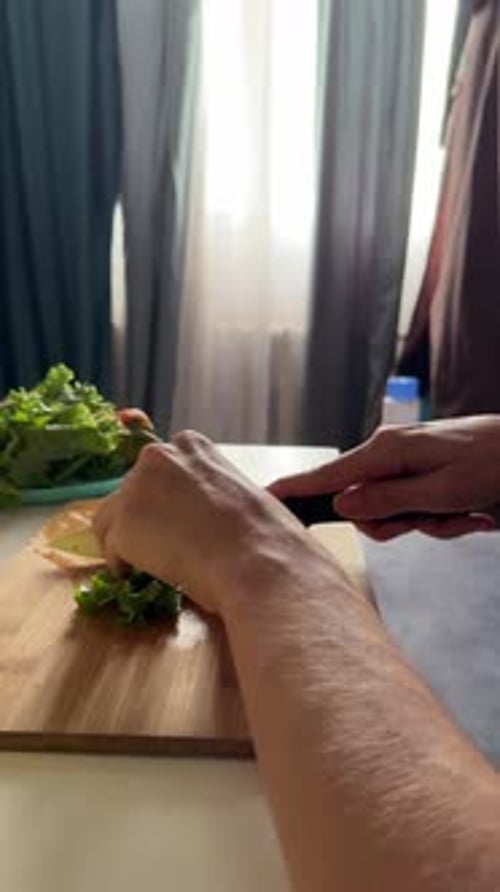 Woman's Hands Chopping Fresh Green Lettuce on Wooden Board Preparing Healthy Salad with Natural