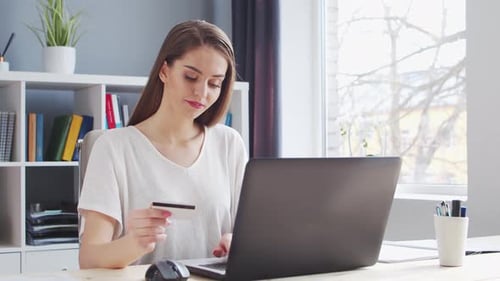 Young Woman Makes Online Purchases on the Internet Using a Bank Credit Card Workplace of Female