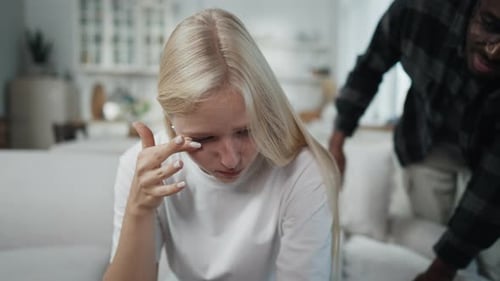 Young Woman Crying with Supportive Man Comforting