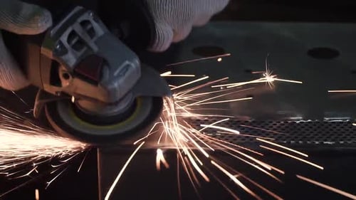 Metal Worker Sparks Flying Close Up in Dark Factory