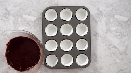 Flat Lay Scooping Chocolate Cupcake Dough Into the Cupcake Liners