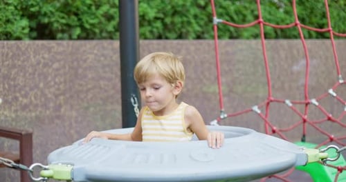 Child Playing on Playground Climbing Equipment