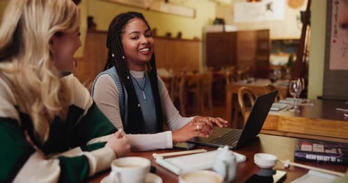 Woman, team and communication with laptop at cafe for meeting, discussion