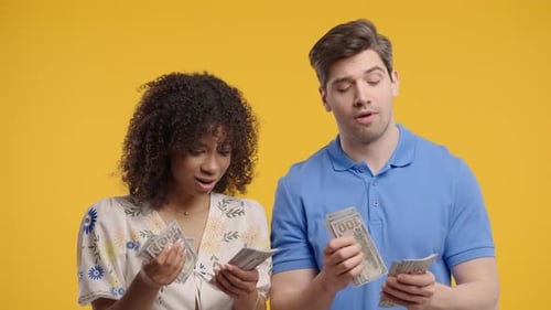 Rich Couple With USD Banknotes Cash Man And Woman Counting Money on Yellow