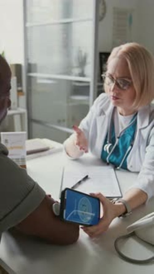 Doctor Explains Medical Data to Patient Using Phone