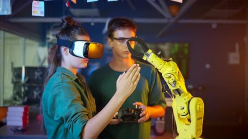 Young Adults Work With Robot Arm and VR Headset