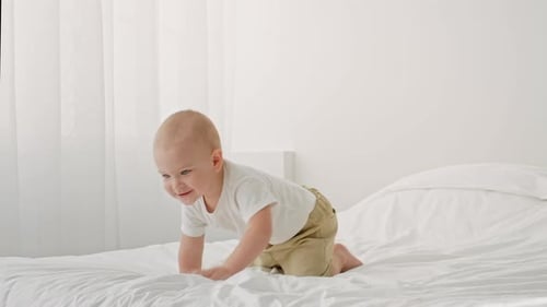 Toddler Crawling on a Bed in a Bright Cozy Home Environment