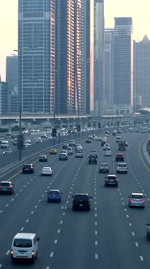 A Modern Urban Highway Gracefully Weaves Its Way Through Towering Skyscrapers at Sunset