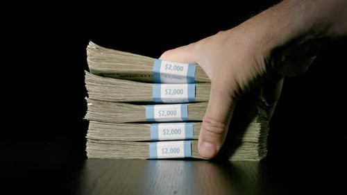 Hand Slamming Money Onto Table