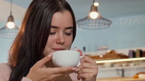 Woman Smiling Enjoying Coffee in Cafe Close Up