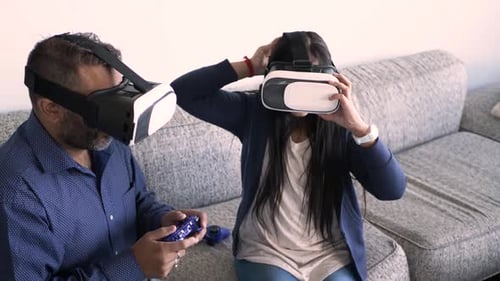 Father and Teen Daughter Use VR Headsets at Home