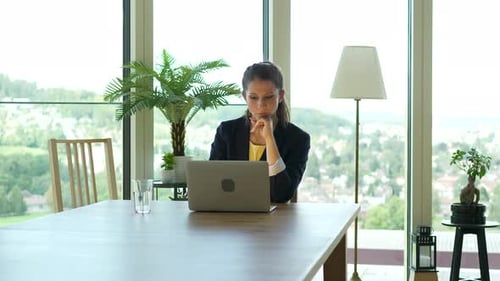 Female Business Person Working on Laptop Computer Desk in City Office