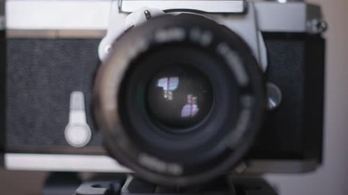 Close up of classic film camera's aperture closing and opening as a photo is taken