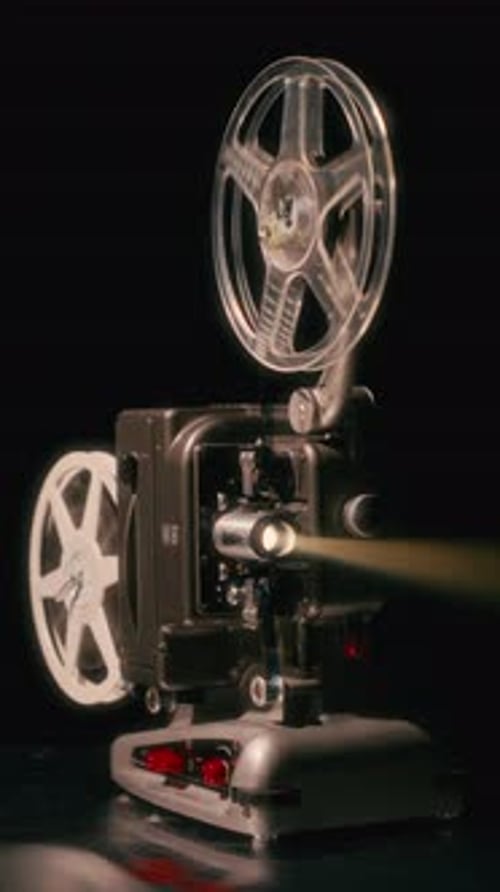 Vintage Film Projector Operating in Dark Studio