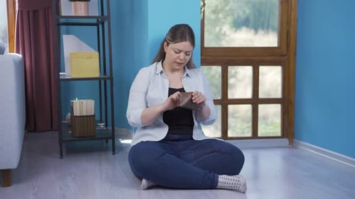Adult Woman Counting Coins From Her Wallet