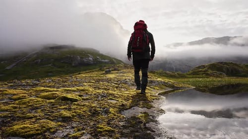 Backpacker Hiking in Nature in Mountainous Landscape