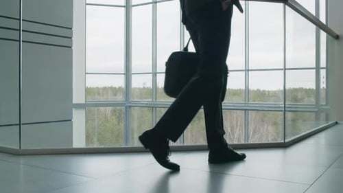 Businessman Waiting for Business Partner in Office Atrium