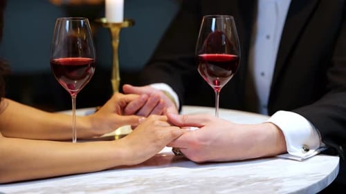 Man Touching Female Hands While Having Romantic Dinner in the Restaurant Cropped Close Up Lifestyle