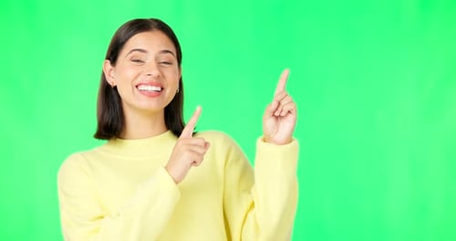 Portrait, pointing and green screen with a marketing woman in studio for advertising