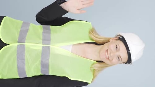 Vertical video of Engineer waving at camera.