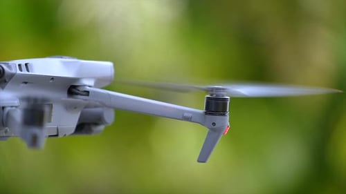 Zumbido con cámara digital y hélices de rotación rápida volando tomando Vídeo y fotografías