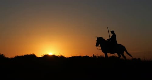 Lone Horseback Rider at Golden Sunset