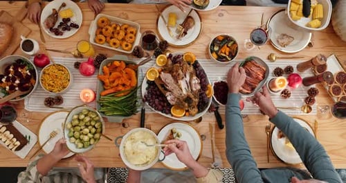 Overhead View of Friends Serving Thanksgiving Dinner Together