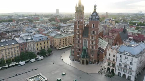 Drone Flies Between Towers of St. Mary's Basilica in Krakow, Poland at Sunrise