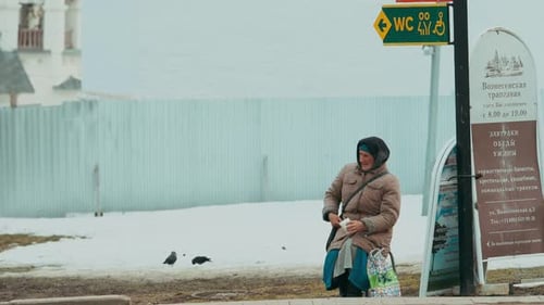 poverty, homeless - elderly man begs for alms in snow-covered Moscow