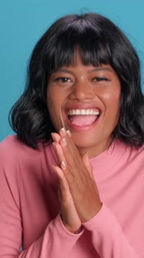 Joyeuse femme asiatique et africaine souriant brillamment sur un fond vibrant