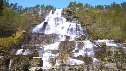 The spectacular Tvindfossen waterfall is located in sunny Voss, Norway.