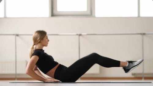 Woman Exercising Core Muscles on Mat Indoors