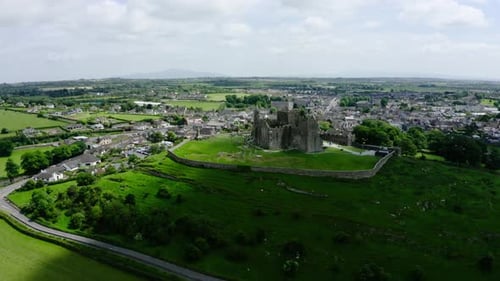 Wide establishing shot of Ireland's Rock of Cashel surrounded by green countryside.