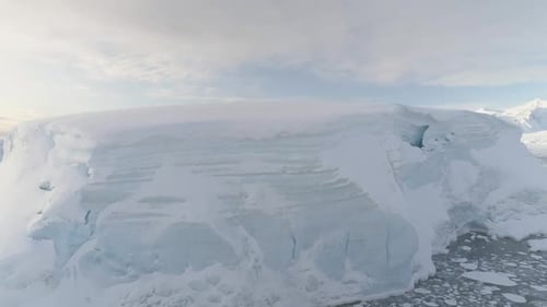 Blue Ice Cave in White Glacier on Antarctic Peninsula Aerial Shot Closeup