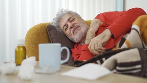 Man With Cold Lying on Couch