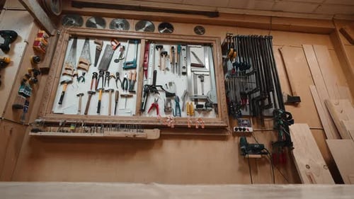 Organized Workshop Wall with Various Carpentry Tools and Equipment