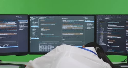 Tired Asian Woman Developer Sleeping While Write Code With Multiple Screens In Green Screen Studio