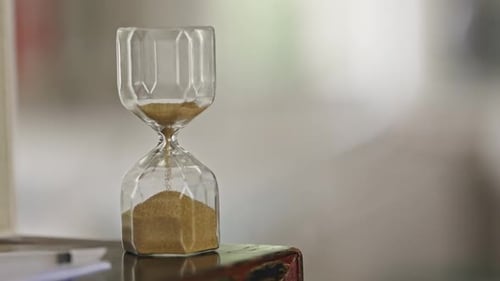 A Sand Timer is on a Table