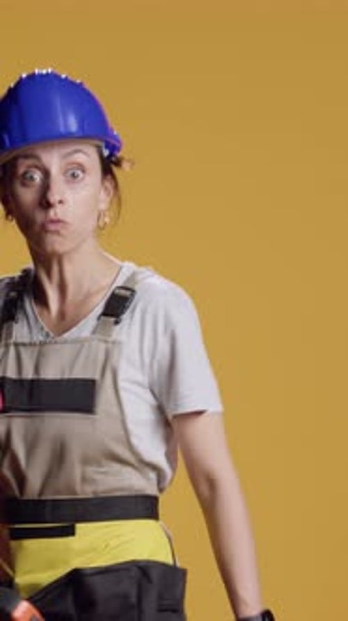 Vertical Video Portrait of Empowered Female Builder Acting Dangerous with Hammer
