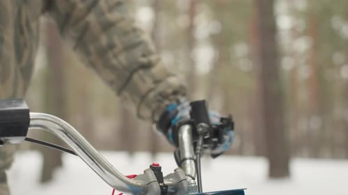 Handling Allterrain Vehicle Across Snowy Pine Trail with Precision Guiding ATV Through Icy Forest
