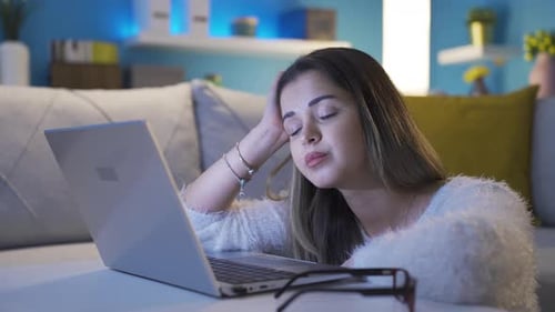 Tired Woman Typing on Laptop at Night