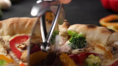 Cutting a Vegetable and Cheese Pizza into Slices